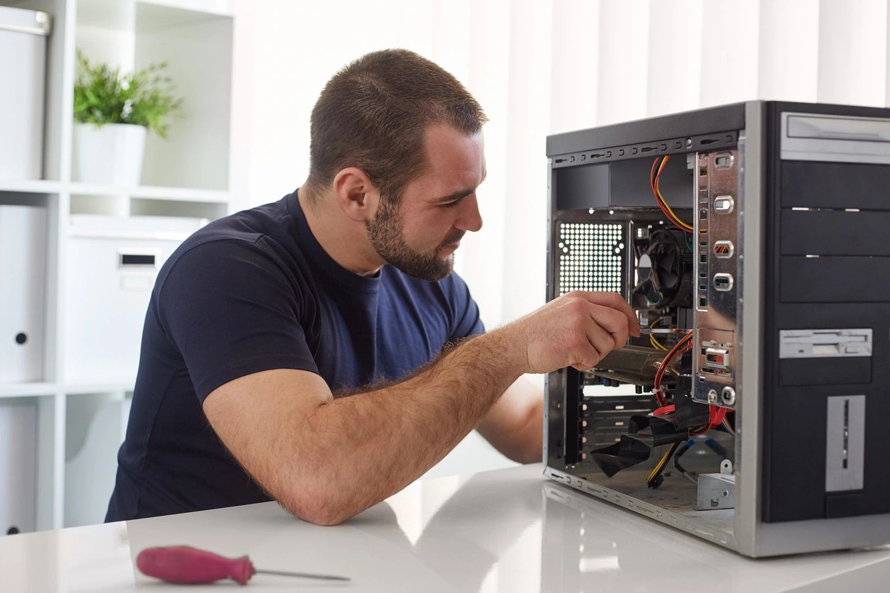 IT technician repairing a desktop computer
